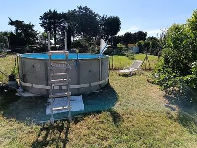 a bath tub sitting in a yard with a ladder at L'Escale Pernoise, 2-6 personnes in Pernes-les-Fontaines