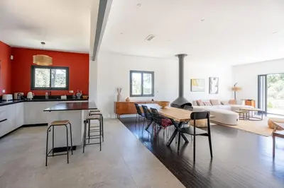 a kitchen and living room with a table and chairs at Magnifique Villa à 5 minutes d'Aix in Aix-en-Provence