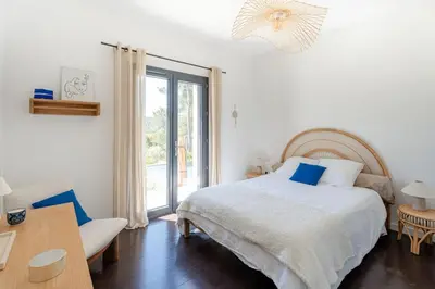 a bedroom with a bed and a large window at Magnifique Villa à 5 minutes d'Aix in Aix-en-Provence