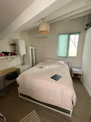 a bedroom with a bed with a laptop on it at inactive in Aix-en-Provence