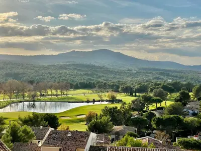 a golf course with a lake and mountains in the background at Maison en Provence avec Piscine et Climatisation - FR-1-658-36 in Mallemort