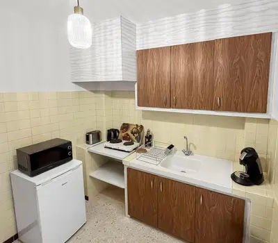a small kitchen with a sink and a microwave at Les Terrasses de l'Adrech in Banon