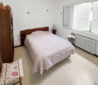 a bedroom with a bed and two windows at Les Terrasses de l'Adrech in Banon