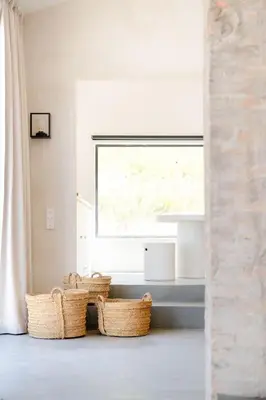 a room with baskets in front of a window at La Bergerie Ferme du Montaiguet in Aix-en-Provence