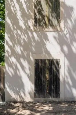 a door in the side of a white building at La Bergerie Ferme du Montaiguet in Aix-en-Provence