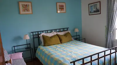 a bedroom with a bed with a blue wall at Bastide Clementine in LʼIsle-sur-la-Sorgue