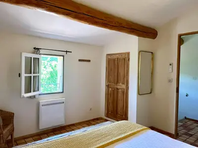 a bedroom with a bed and a window at Provençal Villa With Luberon Views in Céreste