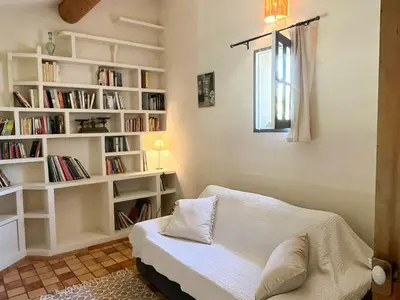 a living room with white bookshelves and a couch at Provençal Villa With Luberon Views in Céreste