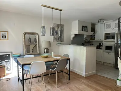 a kitchen and dining room with a table and chairs at Maison village provençal in Éguilles