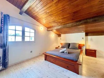 a bedroom with a bed with a wooden ceiling at Casa Corniou - Calme, Village Provençal, 3 chambres, 2 SDB, 8 personnes in Cornillon-Confoux