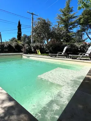 an empty swimming pool with turquoise water at Maison en Provence 7 personnes avec piscine in Carpentras