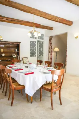 a dining room with a white table and chairs at Artist's Villa With Pool Near Aix-En-Provence in Alleins