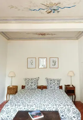 a bedroom with a bed and two lamps and a ceiling at Artist's Villa With Pool Near Aix-En-Provence in Alleins
