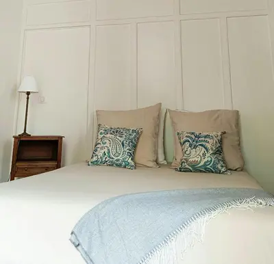 a bed with pillows and a headboard with at Artist's Villa With Pool Near Aix-En-Provence in Alleins