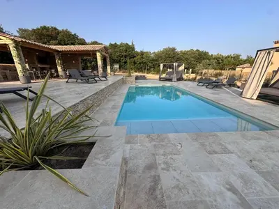 a swimming pool with a patio and a house at Keur Bouyo - Provençal Luxury Retreat in Saint-Saturnin-les-Apt