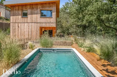 a house with a swimming pool in the yard at Cabane dIsmou Pool & Wood Design in La Roque-dʼAnthéron