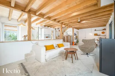 a living room with a white couch and a table at Cabane dIsmou Pool & Wood Design in La Roque-dʼAnthéron