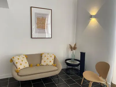 a living room with a couch and a table at Le clos de la Touloubre in Aix-en-Provence