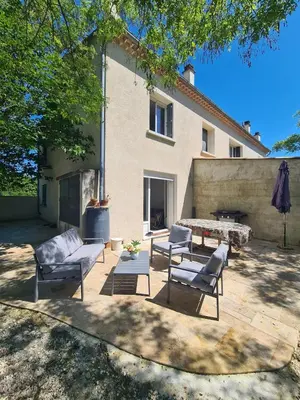 a patio with chairs and a table and a building at Villa avec piscine en Provence in Pernes-les-Fontaines
