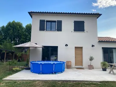 a house with a blue tank in front of it at La Petite Bastide en Provence in Noves