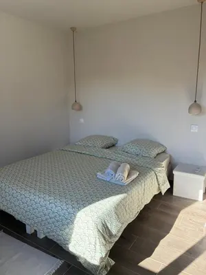 a bedroom with a bed with towels on it at La Petite Bastide en Provence in Noves