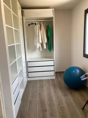 a walk in closet with white cabinets and a blue ball at La Petite Bastide en Provence in Noves