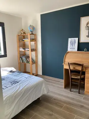 a bedroom with a bed and a desk and a chair at La Petite Bastide en Provence in Noves