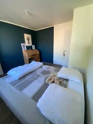 a bedroom with a large bed with a teddy bear on it at La Petite Bastide en Provence in Noves