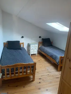 two beds in a room with a window at Charming village house in Alleins