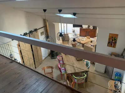 a room with a balcony with chairs and tables at Charming village house in Alleins