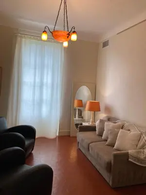 a living room with a couch and a mirror at La Suite Gregoire in Apt