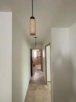 an empty hallway with a light hanging from a ceiling at le petit 105 villa neuve avec piscine in La Fare-les-Oliviers