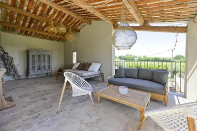a living room with a couch and a table at Villa Les Escapades d'Adrien, piscine, climatisation in Sannes