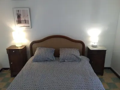 a bedroom with a bed with two lamps on it at Tranquility of Lub in this duplex in La Bastide-des-Jourdans