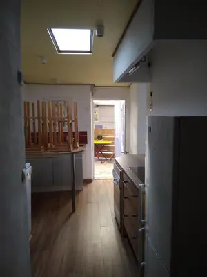 a kitchen with a refrigerator and a table in it at Tranquility of Lub in this duplex in La Bastide-des-Jourdans