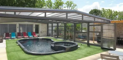 a patio with a hot tub in the middle of a yard at Le logis de la castagne in Caumont-sur-Durance