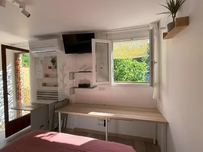 a small room with a desk and a window at Studio terrasse in Aix-en-Provence
