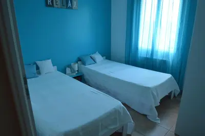 two beds in a room with blue lighting at les lauriers in Caromb