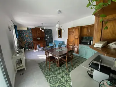 a kitchen with a table and a dining room at Chez Simone, maison calme et indépendante, piscine in Cavaillon