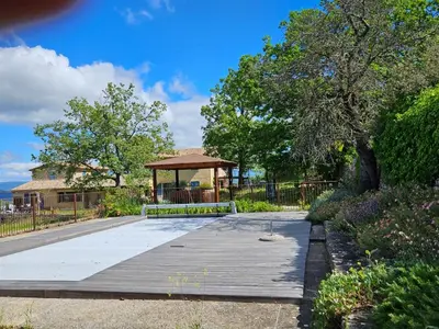 a park with a gazebo on a boardwalk at Vues imprenables, calme, nature, confort in Bonnieux