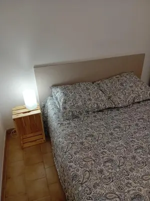 a bedroom with a bed and a night stand at Provencal-style villa in Morières-lès-Avignon