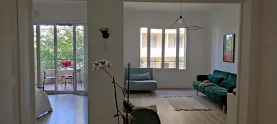 a living room with a green couch and a table at 2 bedroom apartment in the city center in Aix-en-Provence