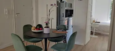 a dining room table with chairs and a bowl of fruit at 2 bedroom apartment in the city center in Aix-en-Provence