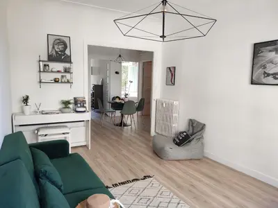 a living room with a green couch and a table at 2 bedroom apartment in the city center in Aix-en-Provence