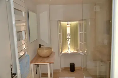 a bathroom with a bowl on a table and a window at La Serre in Viens