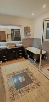 a large bathroom with two sinks and a tub at le mas du luberon rouge in Cheval-Blanc