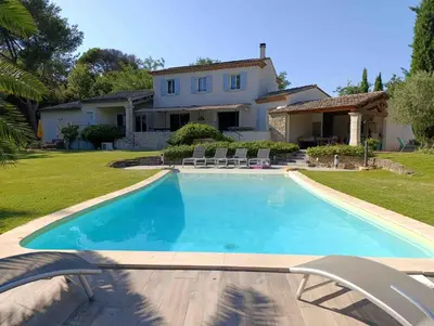 a swimming pool in front of a house at le mas du luberon rouge in Cheval-Blanc