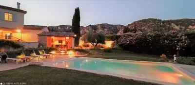 a backyard with a swimming pool and a house at le mas du luberon rouge in Cheval-Blanc