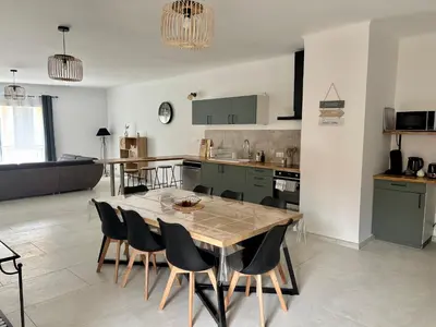 a kitchen and dining room with a table and chairs at Appartement 100 m carré pour 6 à 8 personnes in Saint-Cannat