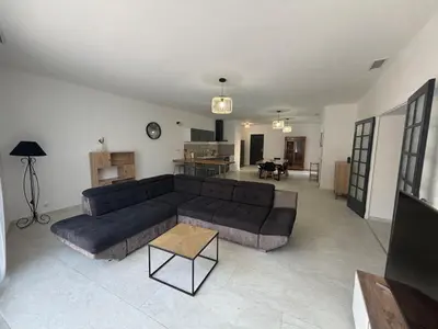 a living room with a couch and a table at Appartement 100 m carré pour 6 à 8 personnes in Saint-Cannat